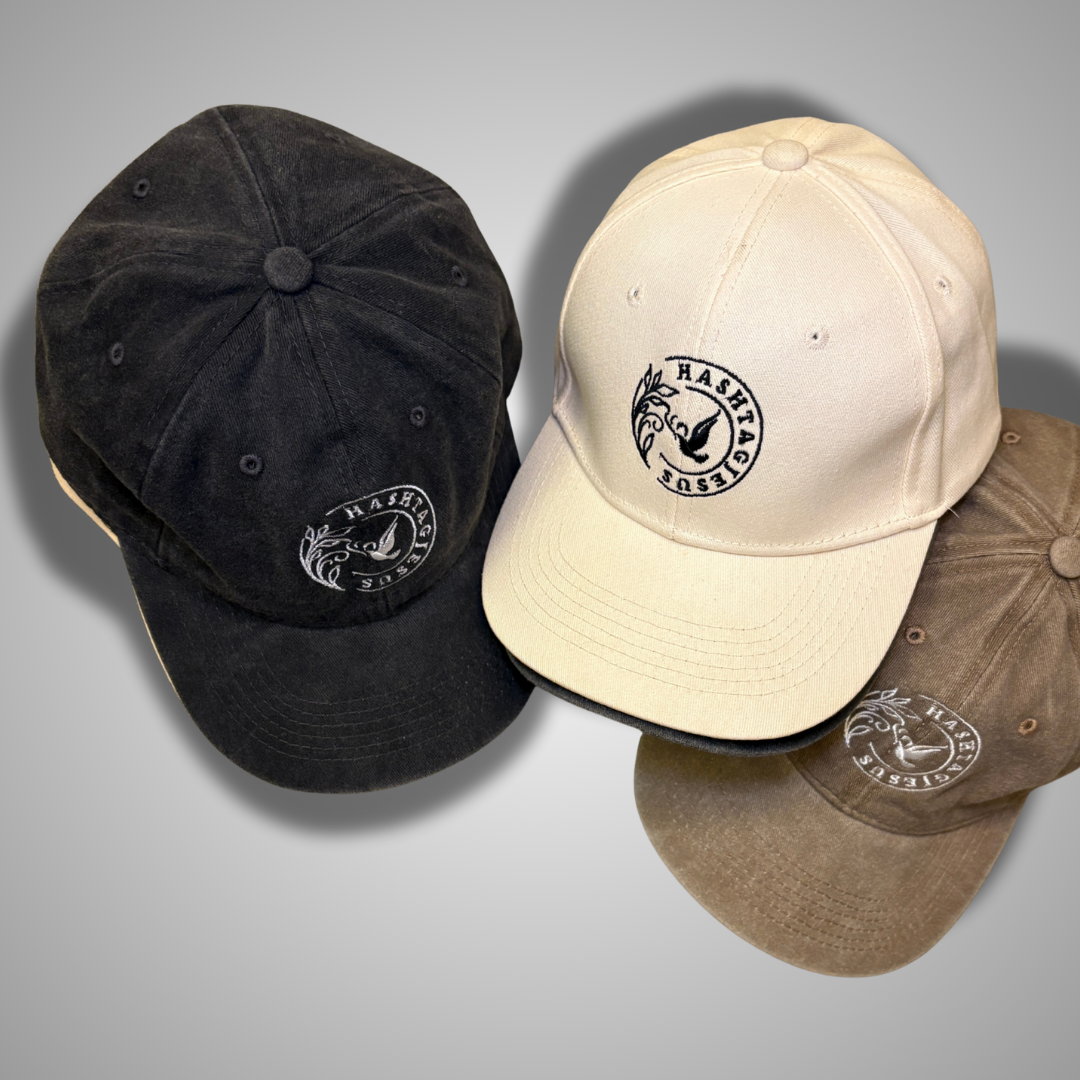 #Jesus caps close-up showing embroidered dove logo — black, cream, and khaki colors